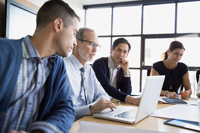 Man on laptop at meeting