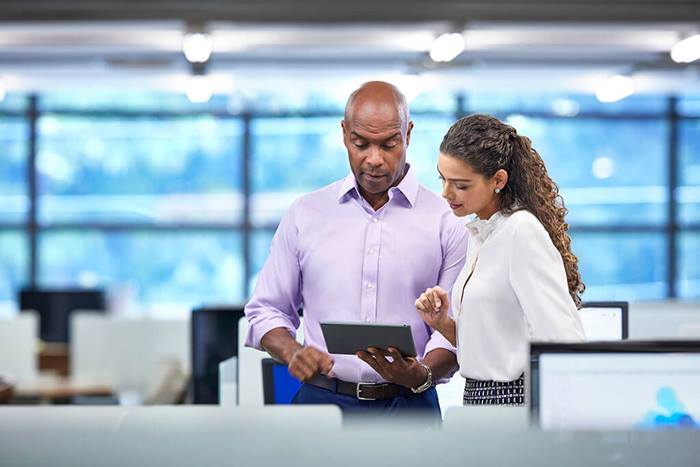 two professionals in desk area